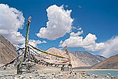 Ladakh - pile of stones on  mountain pass with the characteristc prayer flags